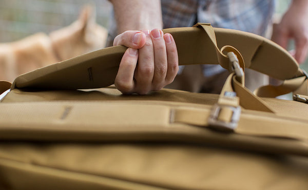 Squeezing those incredibly comfortable Edgeless Shoulder Straps to show off how much cush and support they offer.